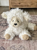 A stuffed sheep toy with plush white faux fur and crocheted accents.