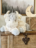 A highland cow stuffed animal with plush white and silver faux fur. 