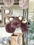 A plush brown moose lovey made by ClaraLoo with soft faux fur and crocheted ears.
