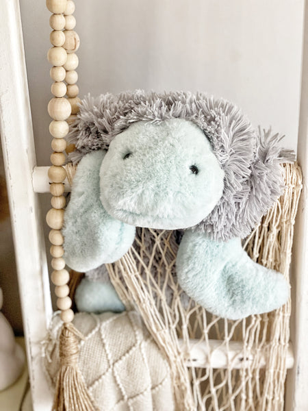 A plush turtle security blanket made by ClaraLoo with soft green and gray faux fur.