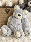 A large plush bear stuffed animal made by ClaraLoo with soft gray faux fur and crocheted accents.