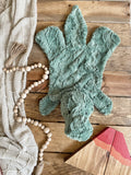 A plush green dinosaur lovey made by ClaraLoo. This T-Rex baby blanket is made with soft green faux fur.